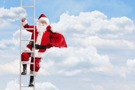 Santa Claus with a sack on a ladder in the skyの写真素材