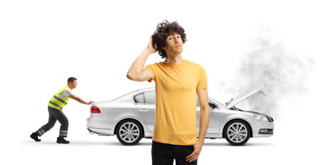 Pensive young man with inoperable car waiting for roadside help isolated on blue background