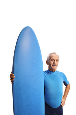 Elderly man in a wetsuit with a surfing board isolated on white backgroundの写真素材