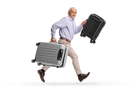 Elderly man running with suitcases isolated on white backgroundの写真素材