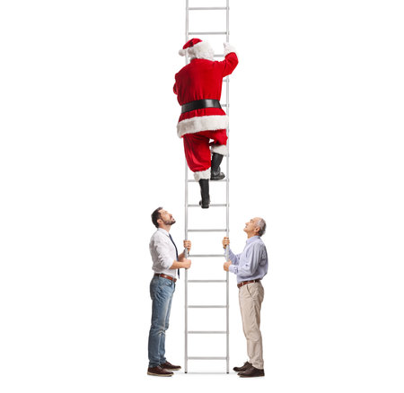Two men holding a ladder and Santa Claus climbing isolated on white backgroundの写真素材