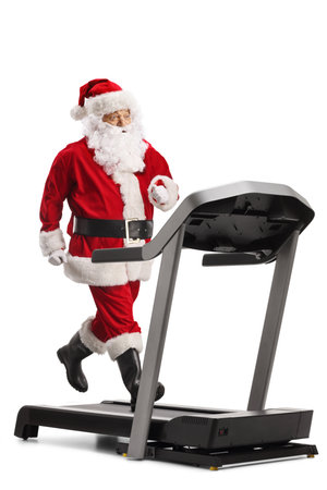 Santa Claus running on a treadmill isolated on white backgroundの写真素材