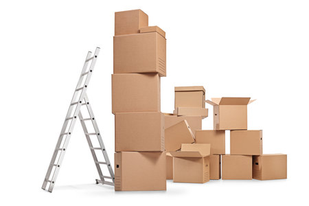 Pile of cardboard boxes and a ladder isolated on white backgroundの写真素材