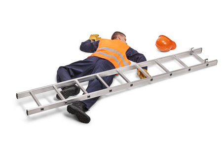 Worker lying on the ground after fall from a ladder isolated on white backgroundの写真素材