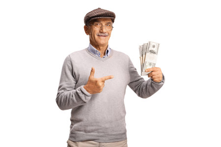 Pensioner holding stacks of money banknotes and pointing isolated on white backgroundの写真素材