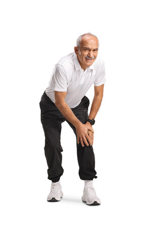Active senior man with knee pain isolated on white backgroundの写真素材