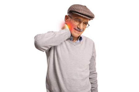 Elderly man suffering from painful neck isolated on white backgroundの写真素材