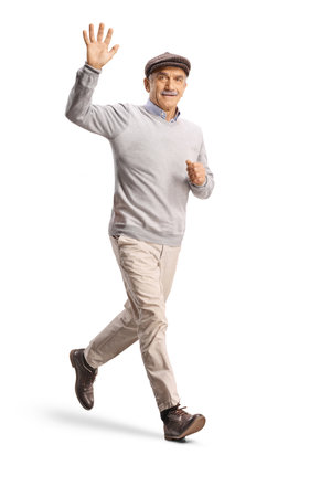 Full length shot of an elderly man running and waving at camera isolated on white backgroundの写真素材