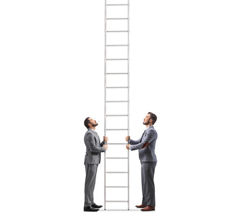 Two businessmen holding a tall ladder, looking up with aspiration isolated on white backgroundの写真素材