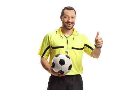 Football referee with a ball gesturing thumbs up isolated on white backgroundの写真素材