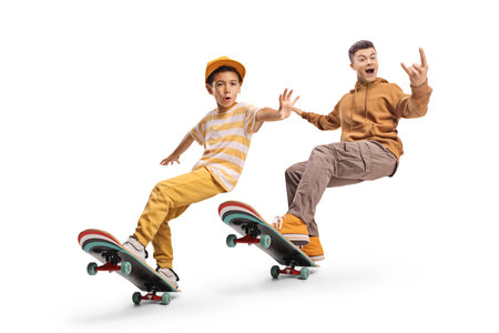 Boys skateboarding and gesturing with hand isolated on white background