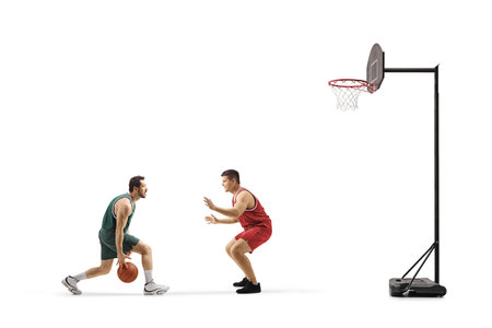 Two men playing basketball one-on-one isolated on white backgroundの写真素材
