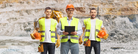 Workers in safety vests and hard hats at an open-pit mine