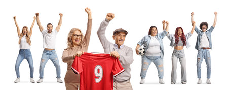 Excited mature couple holding a football jersey and cheering with a group of young people isolated...