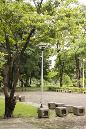 Marble seat, pole lamp in park の写真素材