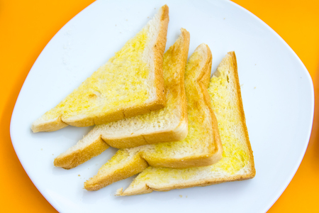Set toast butter and sugar on white plate.の写真素材