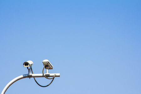 Twin security camera on blue sky background