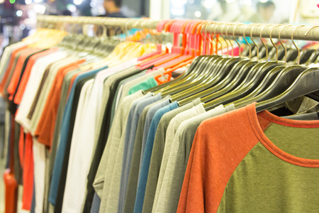 The fashion clothing on hangers at the show in the shop.