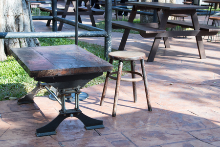 The outdoor wooden table and chair set in the park.の写真素材