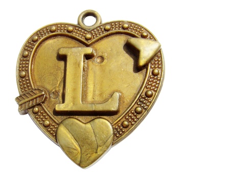 Heart shaped old pendent isolated on whiteの写真素材