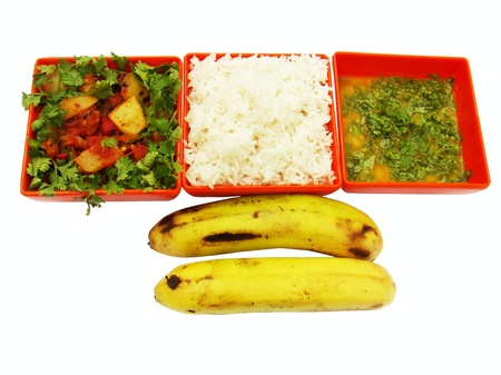  Vegeterian meal isolated on white. Meal contains steamed rice, cooked vegitables, cooked lentils and two ripen banannasの写真素材