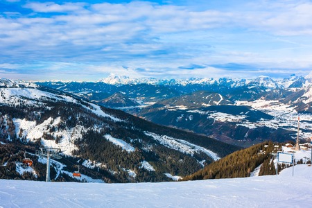 Beautiful winter landscape with fog, clouds, forest, sunの写真素材