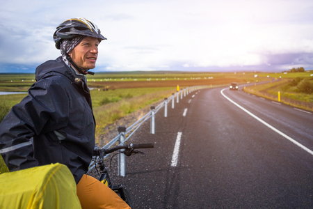 happy man during bicycles trip in Icelandの写真素材
