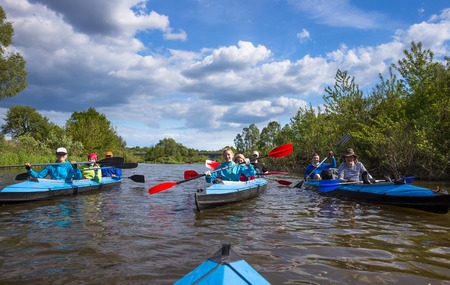 Young people are kayaking in beautiful natureの写真素材