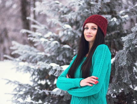 Portrait of a cute brunette in a frosty park