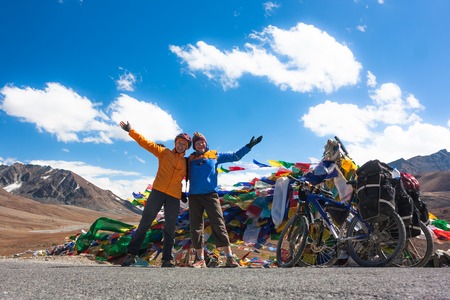 Young happy friends cyclists standing on road in Himalayas mountains , North Indiaの写真素材
