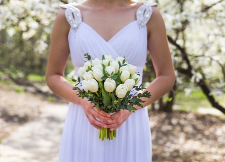 Happy Bride with bouquet in sunny morning wedding dayの写真素材