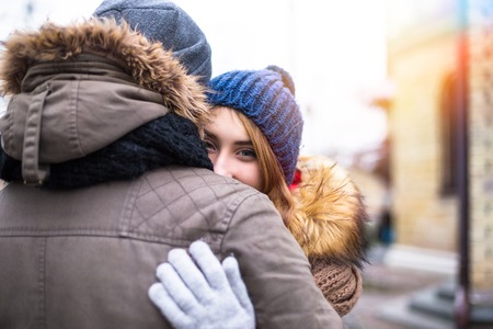 Young happy couple enjoy in winter city park outdoorの写真素材