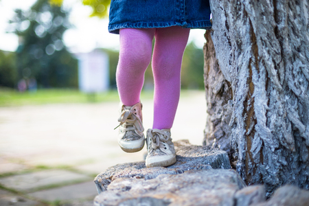 Happy girl-kid walking with her mother in city park.の写真素材