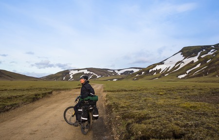 Biker rides on road at summer day in Iceland. Travel and sport pictureの写真素材