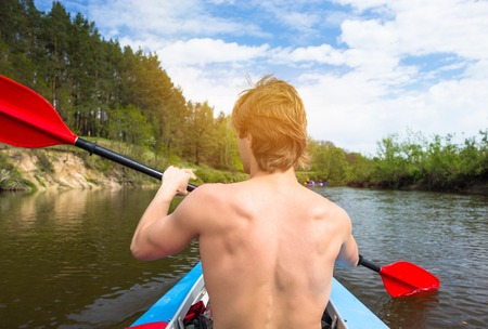 Young people are kayaking on a river in beautiful nature.の写真素材
