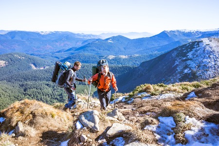 Young happy treveller hiking in beautiful mountains. Fantastic autumn landscape.の写真素材