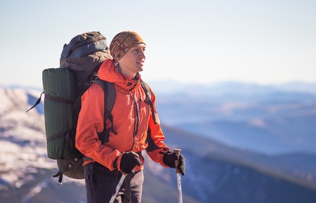 Young happy treveller hiking in beautiful mountains. Fantastic autumn landscape.の写真素材