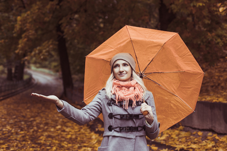 Pretty woman on backdrop of autumn leaves - seasonal relax conceptの写真素材