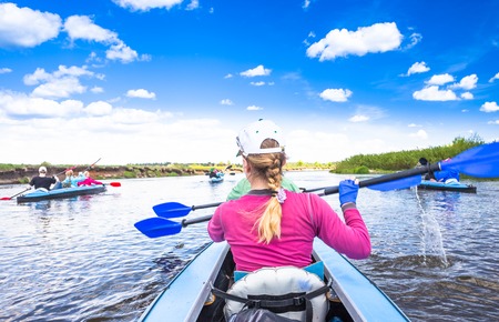 Kayaking on beautiful nature at summer sunny day. Sport people having fun on a river.の写真素材