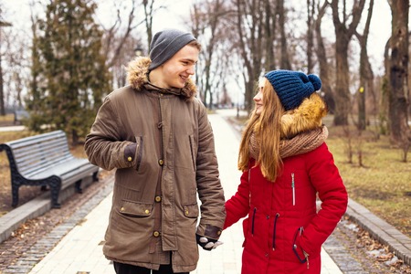 Couple in love walking in winter park and enjoy each others companyの写真素材
