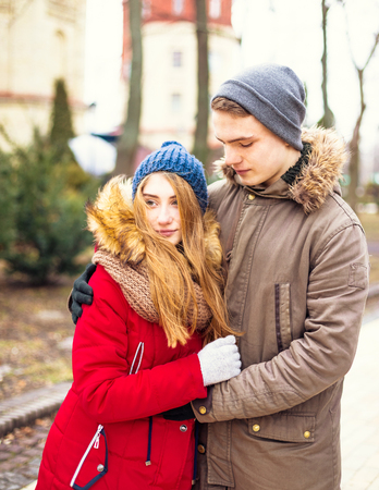 Couple in love walking in winter park and enjoy each others companyの写真素材