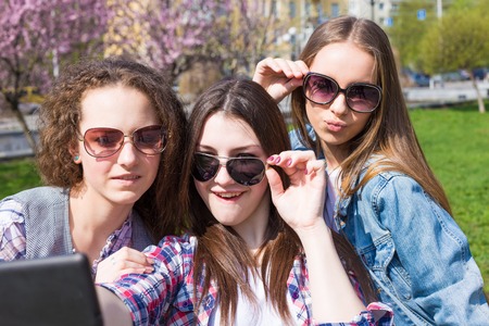 Happy teen girls having fun in streetの写真素材