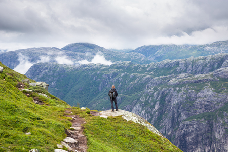 Happy people relax in cliff during trip Norway. hiking routeの写真素材