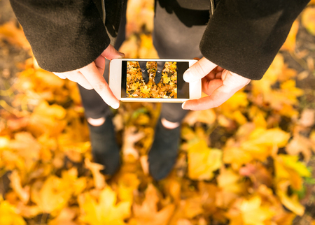 Happy teen girl walking on autumn park. Happy relax time in cityの写真素材