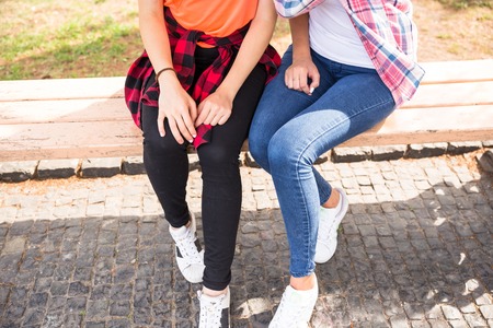 Young happy hipster teenage girls having fun in summer parkの写真素材