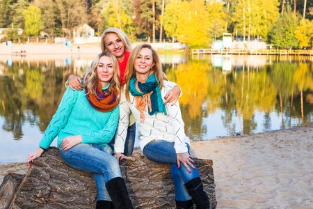 Happy girls having fun spend time together in autumn city park