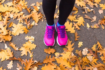Young sport woman doing exercises during autumn training outsideの写真素材