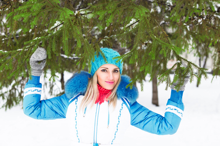 Young happy woman enjoy snow in winter city park outdoor.の写真素材