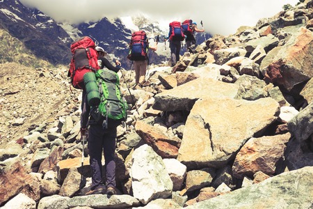 Hiking in beautiful mountains. Group of hikers enjoy the weatherの写真素材