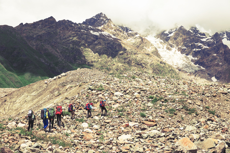 Hiking in beautiful mountains. Group of hikers enjoy the weatherの写真素材